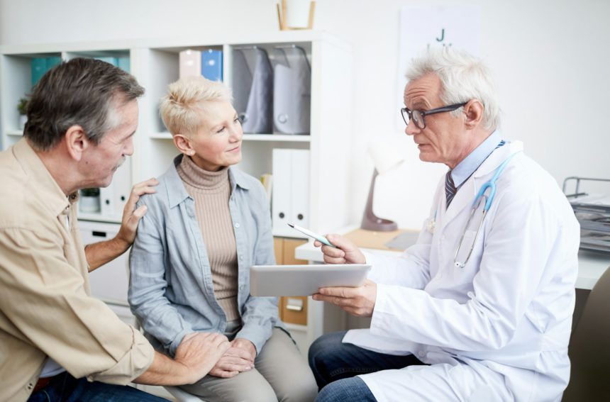 Doctor giving advice to mature woman with serious disease