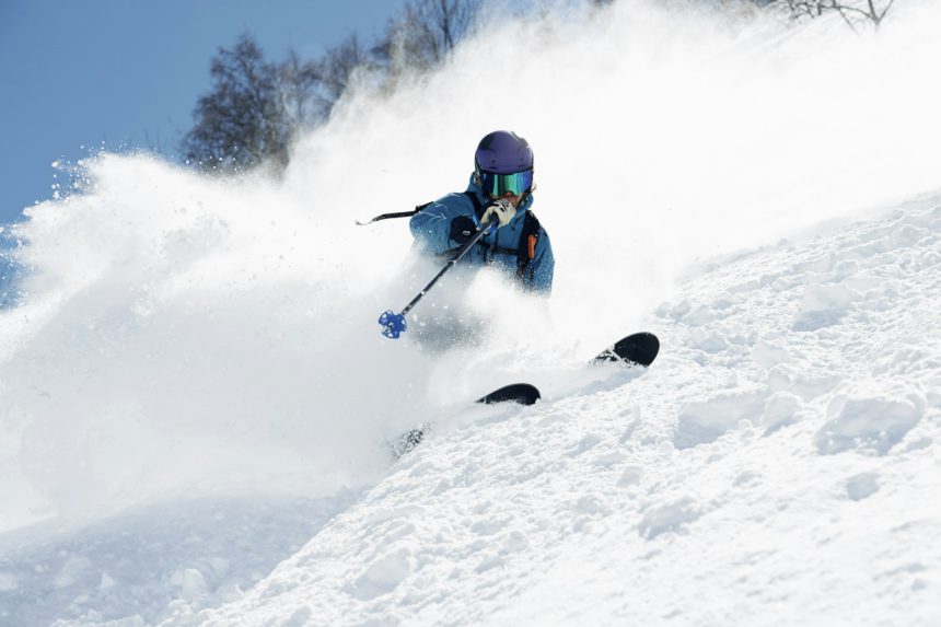 Male skier swerve skiing down mountain, Alpe-d'Huez, Rhone-Alpes, France