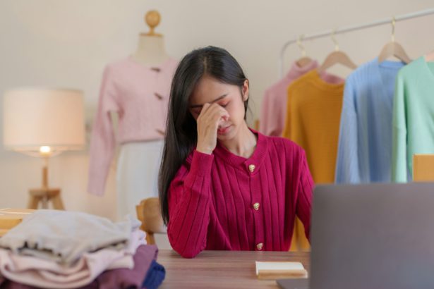 Worried asian female entrepreneur experiencing stress while managing her online